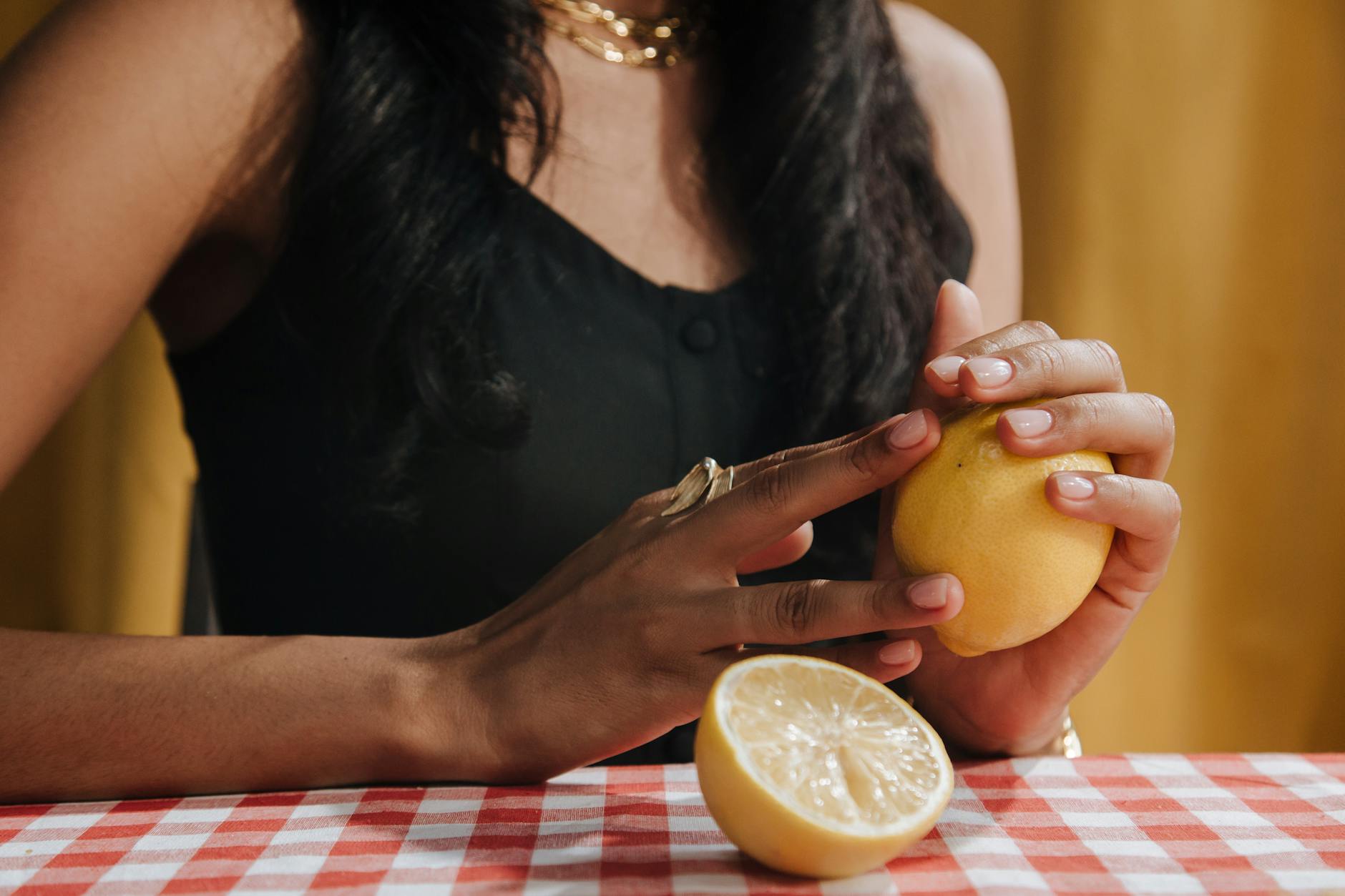 Two hands holding pink and blue silicone vibrators against a pastel background, representing shared pleasure