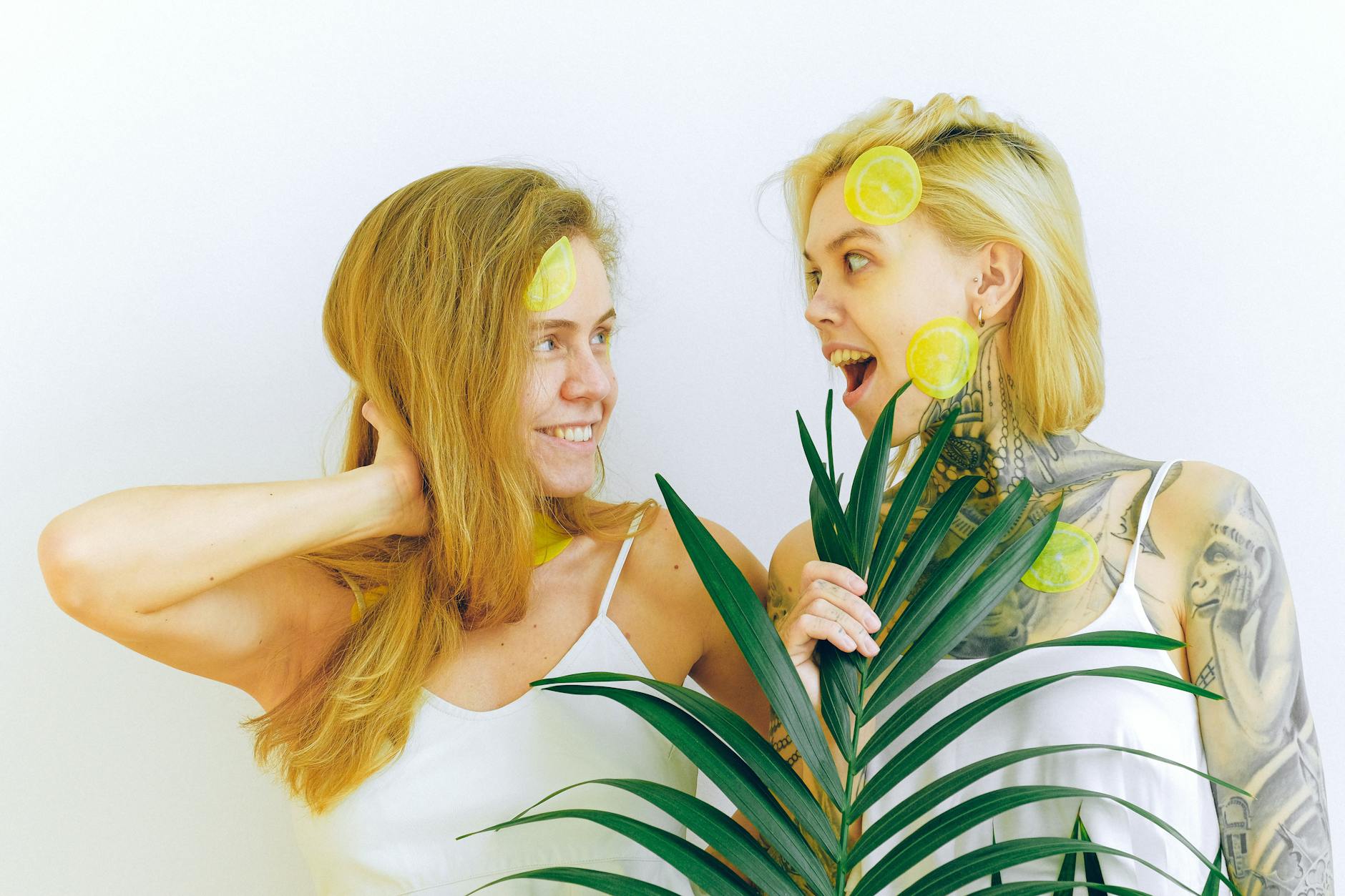 Hand holding a lemon on soft pink background, symbolizing sensuality and arousal during perimenopause.